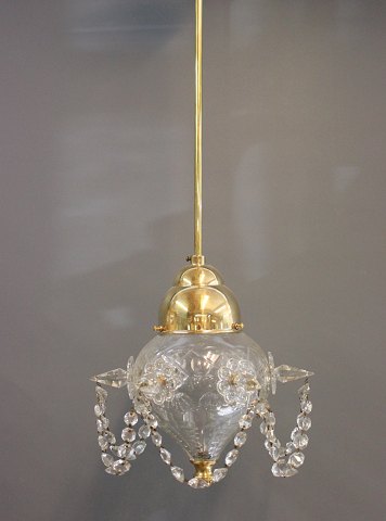 Ceiling lamp with lamp globe and crystals, from around 1930.
5000m2 showroom.