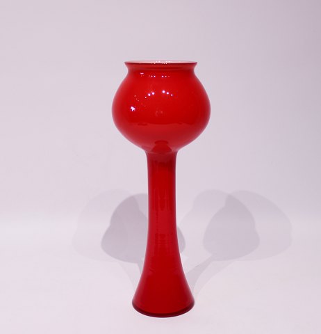 Tall red glass vase with white opaline glass on the inside from Holmegaard.
5000m2 showroom.