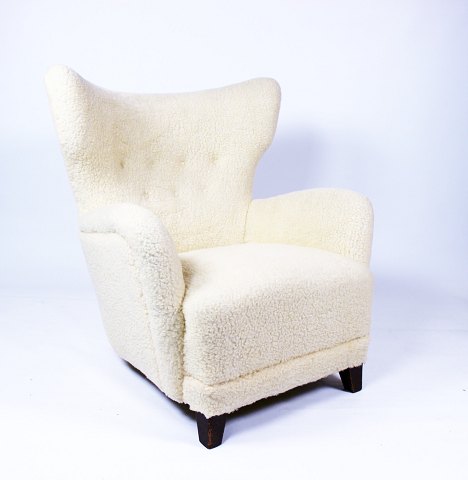 Easy chair from around the 1930s and newly upholstered with sheep skin. 
5000m2 showroom.