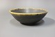 Brown stoneware bowl with a yellow edge by Eigil Henriksen.
5000m2 showroom.