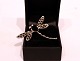Brooch in the shape of a dragon fly, stamped DEUS with stones and of 925 
sterling silver.
5000m2 showroom.