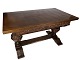 Large antique dining table of dark wood with two extension plates.
5000m2 showroom.