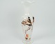 A milky white vase with the composition of golden colors from around the 1970s.
Dimensions in cm: H: 24 D: 9
Great condition
